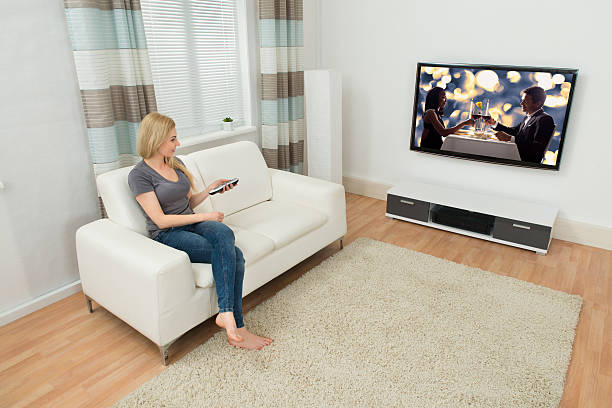 istock Woman On Sofa Watching Movie 513581516