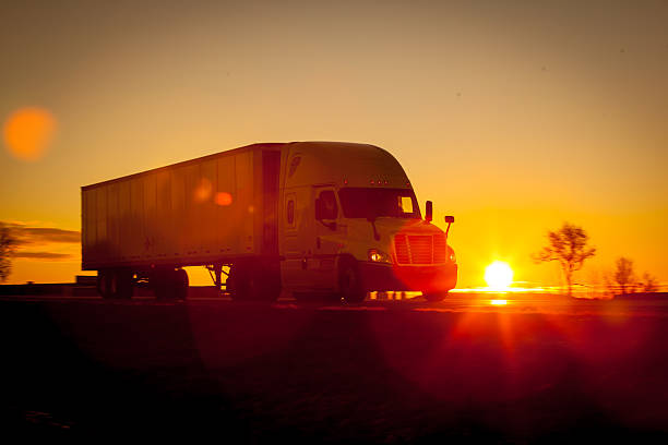 istock Tractor trailer driving down the highway at sunrise. 513581762