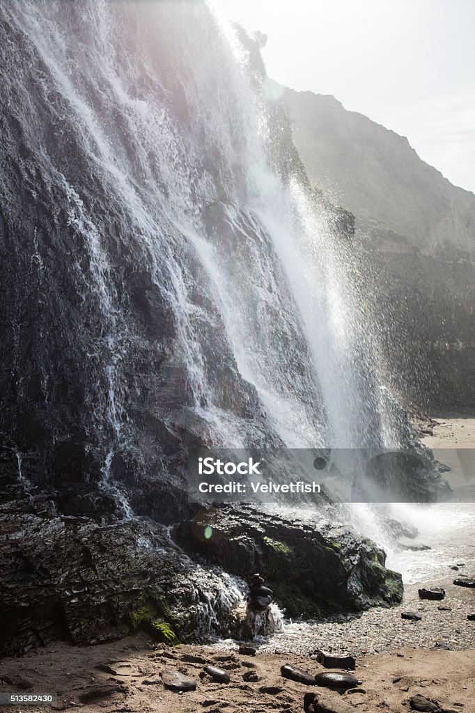 Waterfall in Northern California The Alomere waterfall drops dramatically from a cliff to the beach in Point Reyes National Seashore. This beautiful waterfall is accessed via a four mile trail in Bolinas, CA, north of San Francisco. Adulation Stock Photo