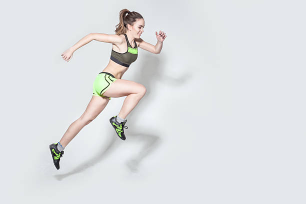 istock running caucasian woman studio isolated on gray 513583338