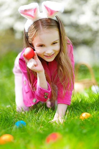 istock Adorable little girl hunting for easter egg on Easter day 513583728