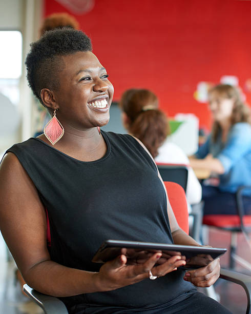istock Confident female designer working on a digital tablet in red 513584572