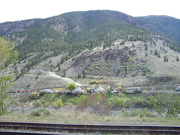 istock Homes along the river and railway 513584656