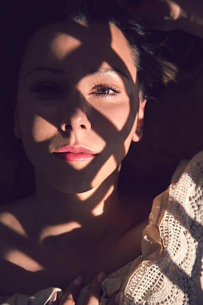 istock girl lying on the sun looking at the camera 513584850