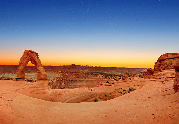 Delicate Arch Panoramic view of Delicate Arch in Arches National Park, Utah, U.S.A. delicate arch stock pictures, royalty-free photos & images