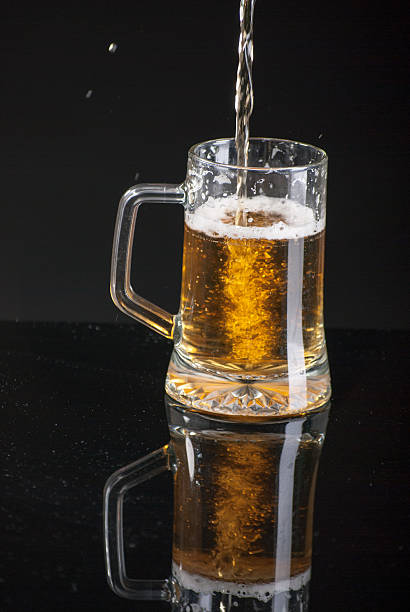 istock Beer glass and beer falling in glass 513587274