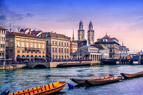 Grossmunster Cathedral with River Limmat in Zurich at Sunset Beautiful Zurich Cityscape. Grossmunster Cathedral with River Limmat, traditional Swiss buildings at sunset. Zurich, Switzerland. zurich photos stock pictures, royalty-free photos & images