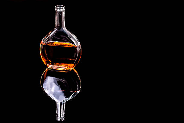 istock Bottle of Brandy on the mirror black surface 513588858