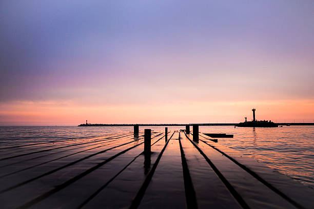 istock Purple sunset on sea with pier 513588860