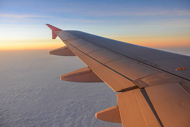 istock Wing of an airplane flying above the clouds 513589870