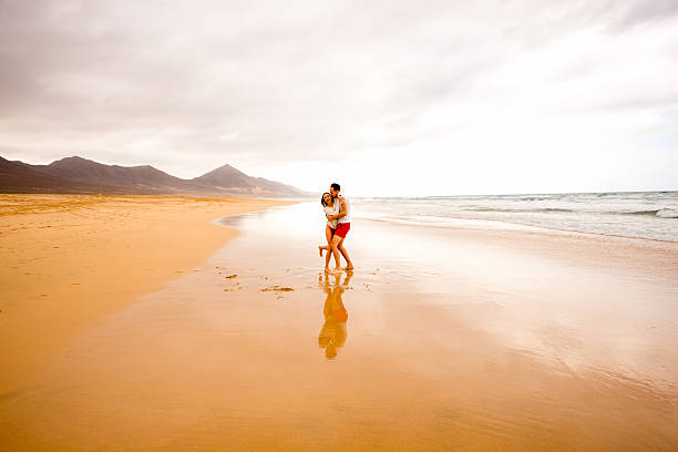 istock Couple having fun on the beach 513589878
