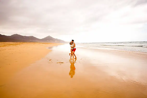 Photo of Couple having fun on the beach