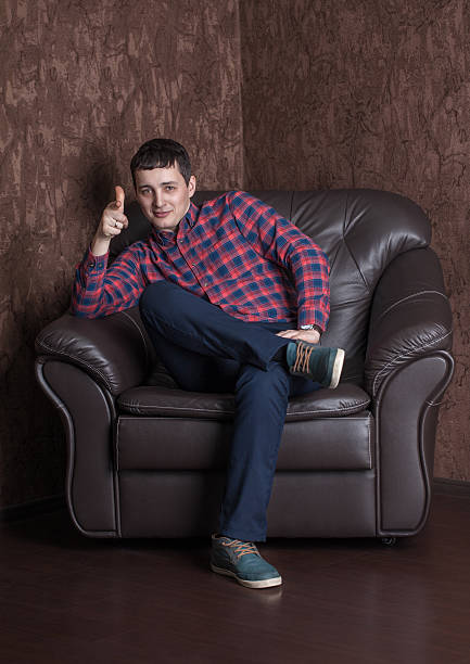 istock Young successful guy sitting on a leather armchair. 513593682