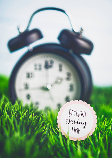 istock Clock in grass with reminder for Daylight Savings Time 513594200