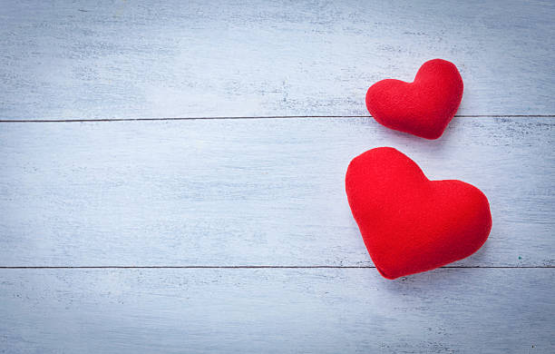 istock Two red heart with space on white wood floor 513594460