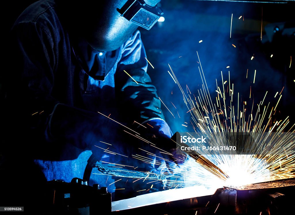 Welder working Industrial steel welder in factory Welder Stock Photo