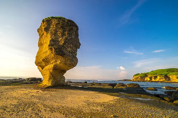 Rock formation with morning sunlight at Batu Payung (Umbrella Rock), Lombok, Indonesia.
