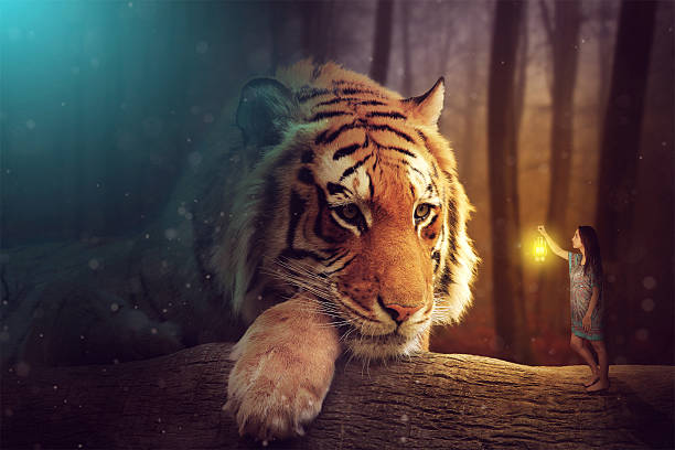 young woman near a giant tiger in a forest