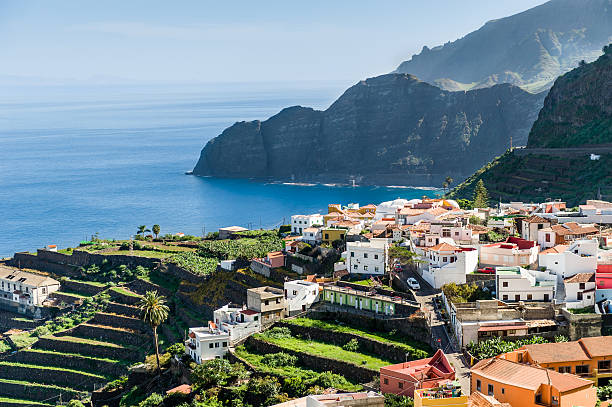 istock Village at Atlantic ocean shore and high rocks. 513600749