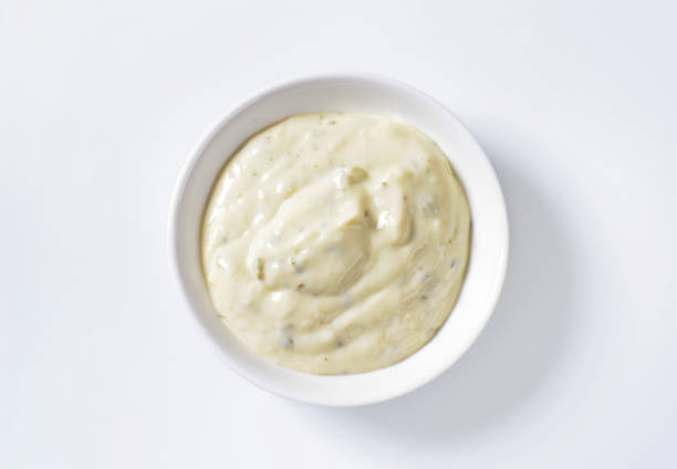 Creamy salad dressing Creamy salad dressing made of mayonnaise, buttermilk, garlic, herbs, spices and grated cheese ranch dressing stock pictures, royalty-free photos & images