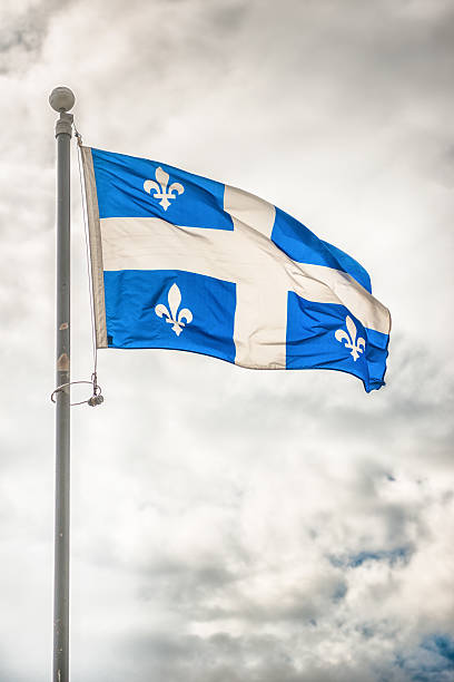 istock quebec flag waving on the sky 513601963
