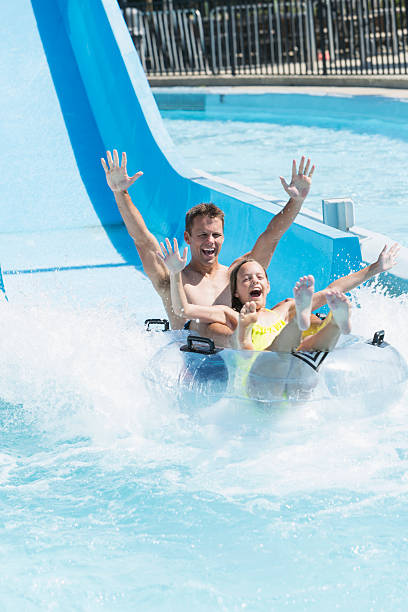istock Father and daughter on water slide 513602185