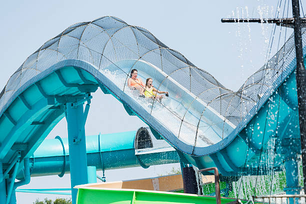 Mother and daughter on water slide