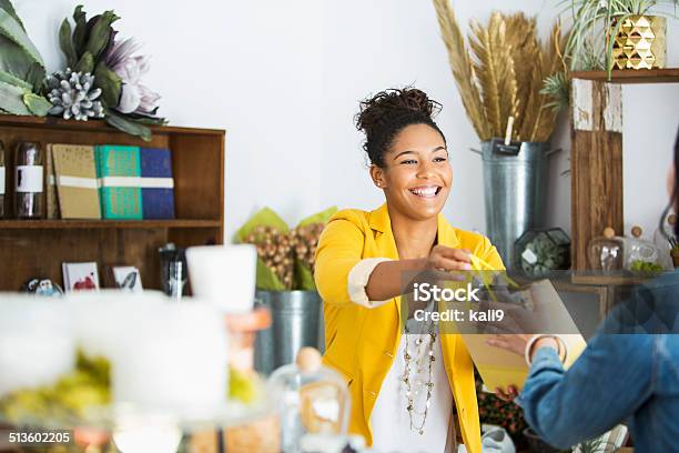 Saleswoman Helping Customer Stock Photo - Download Image Now - Small Business, Retail, Customer
