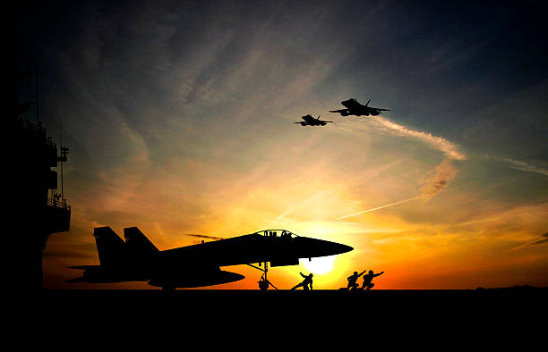 Take-off Military aircraft before take-off from aircraft carrier on sunset background hornet stock pictures, royalty-free photos & images