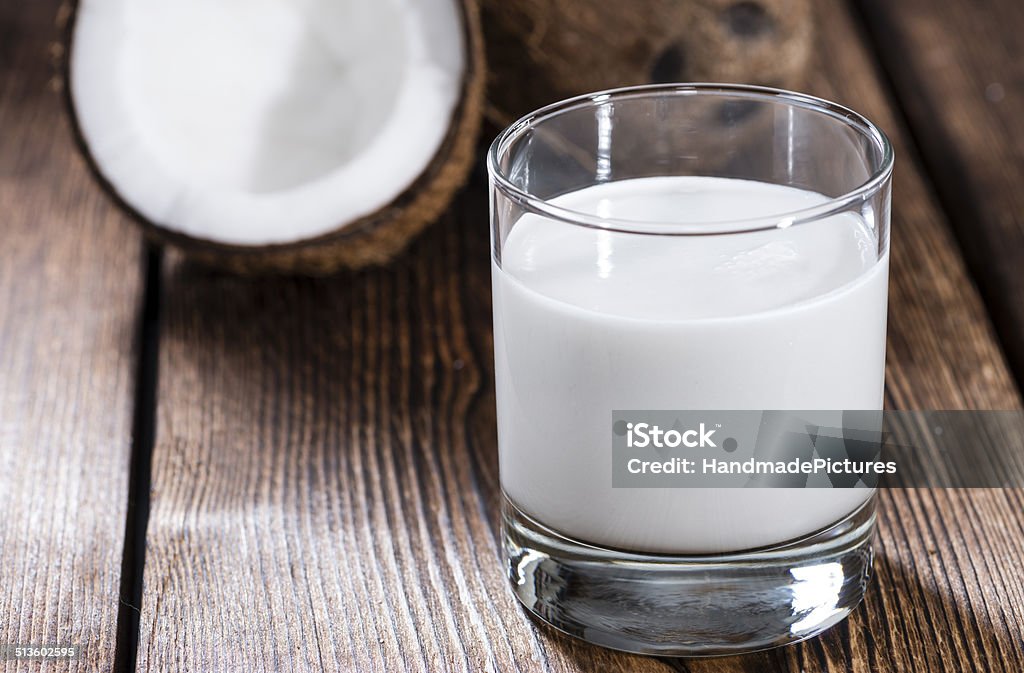 Coconut Milk Coconut Milk in a glass on dark wooden background (close-up shot) Coconut Milk Stock Photo