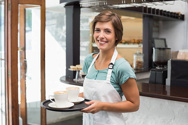 istock Pretty barista smiling at camera holding tray 513602803
