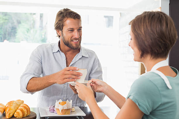 istock Pretty barista serving happy customer 513603437