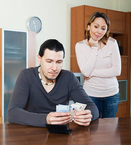istock Man counting money, woman watching 513604083