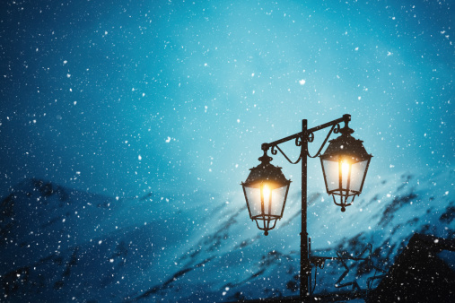 Lamppost in a mountain village on a snowy winter night.