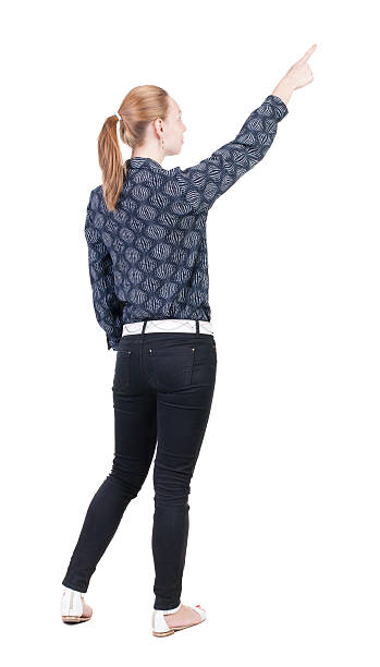 istock Back view of  pointing woman. 513605587