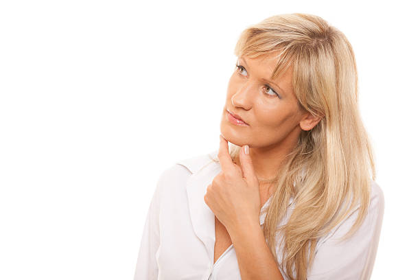 istock Thinking mature woman looking up isolated 513606273