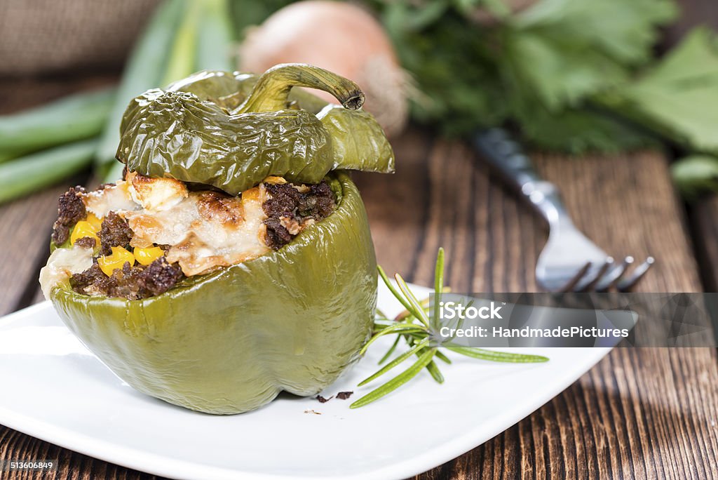 Portion of Stuffed Peppers Portion of Stuffed Peppers (close up shot) on wooden background Appetizer Stock Photo