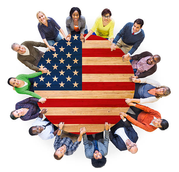 istock People Holding Hands Around the Table with American Flag 513607139