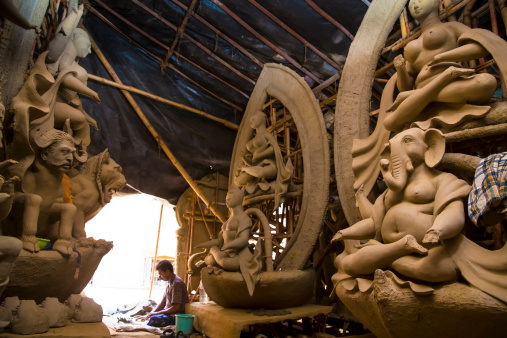 Indian deity - Goddess Durga idols being prepared by artisans for the festival Durga Puja. Artisans from West Bengal-India come to Delhi every year to make these idols for the Durga Puja Festival in Delhi. Its a 5 day long festival which ends with the immersion of these idols in the river.