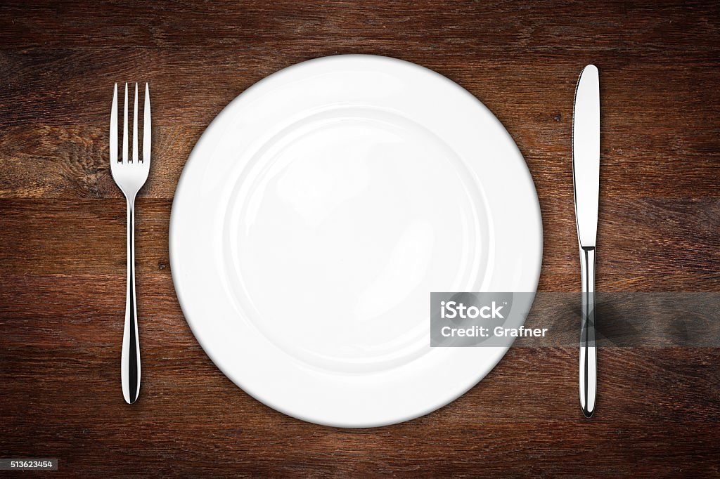 place setting place setting with empty dish fork and knife on wooden background Place Setting Stock Photo