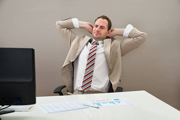 istock Businessman With Hands Behind Head In Office 513625344