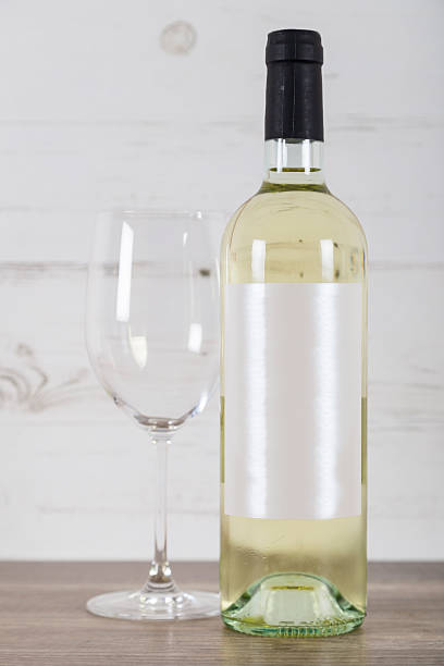 White wine bottle and empty glass