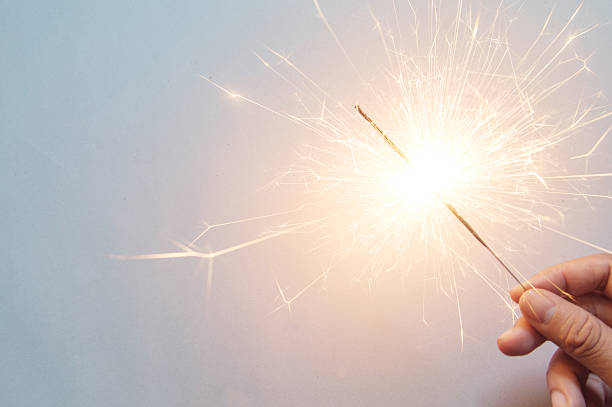 istock man's hand holding a sparkler 513629158