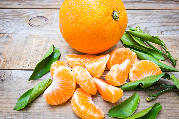 several mature citrus on a wooden table stock photo