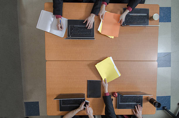 istock Four persons meeting at a table seen from above 513630912