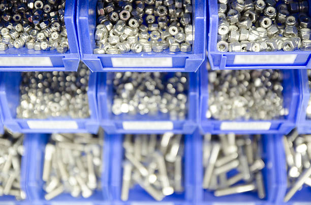 istock Rows blue plastic storage bins containing screws, bolts and nuts. 513631250