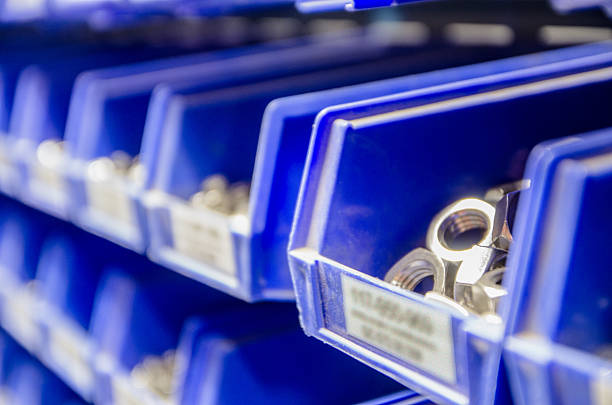 istock Rows blue plastic storage bins containing screws, bolts and nuts. 513631540