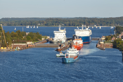 Kiel, Germany - September 3, 2014: The genral cargo ship Wilson Hawk, tanker Eduard Essberger and Ro-ro cargo vessel Finnbreeze are leaving the lock Kiel-Holtenau to the Kiel Canal on September 3, 2014.