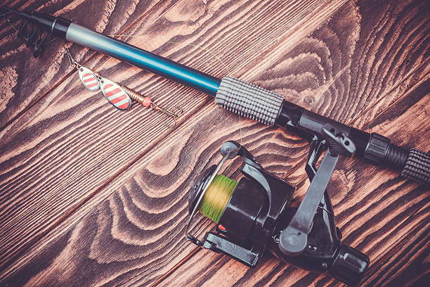 istock fishing tackle on a wooden table 513632983