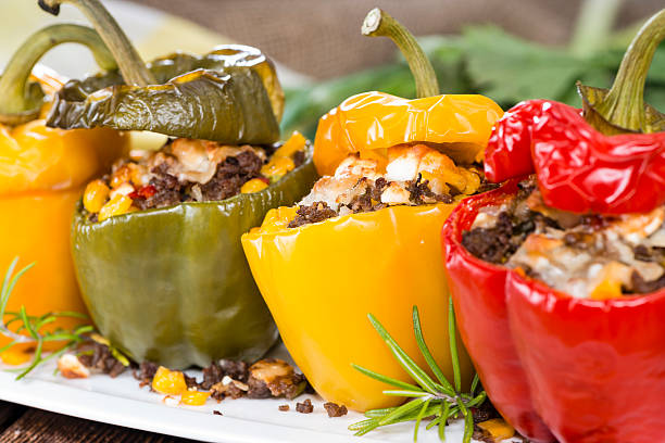 Stuffed Peppers (with Meat, Herbs and Cheese) Stuffed Peppers (with Meat, Herbs and Cheese) on wooden background stuffed pepper stock pictures, royalty-free photos & images